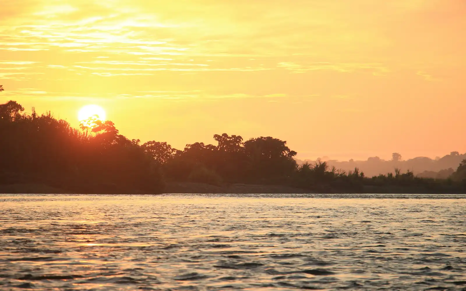 Sunset over a wide Amazon river