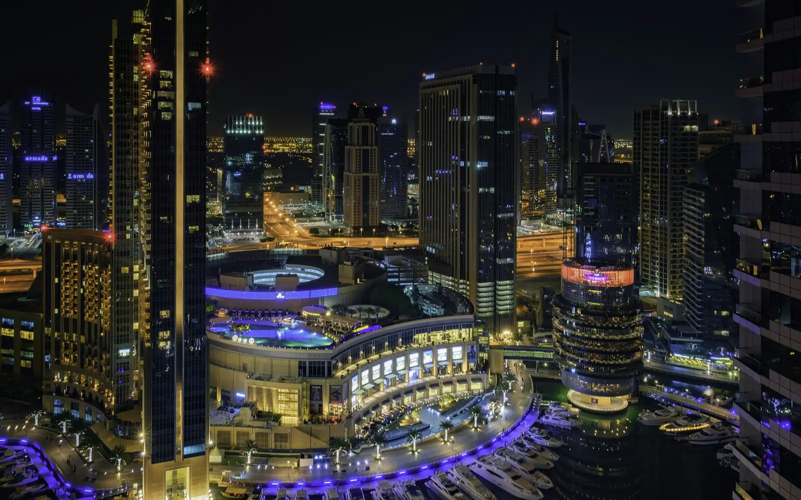 Dubai Marina towers and yachts at night