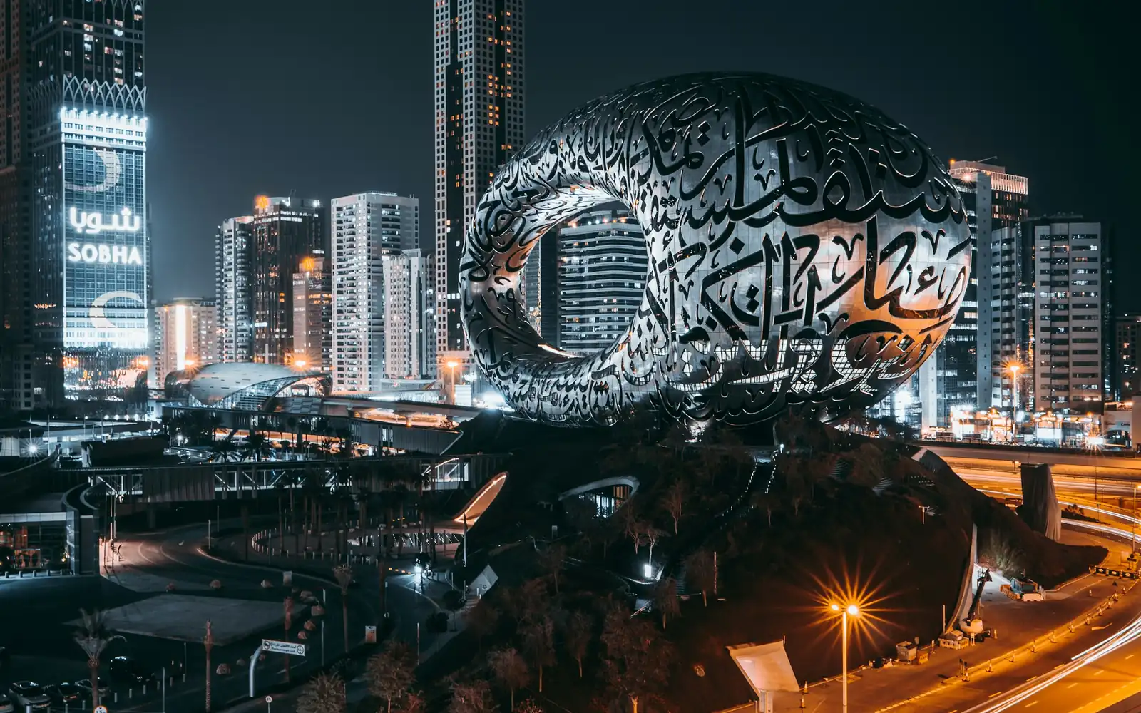 A futuristic museum lit at night