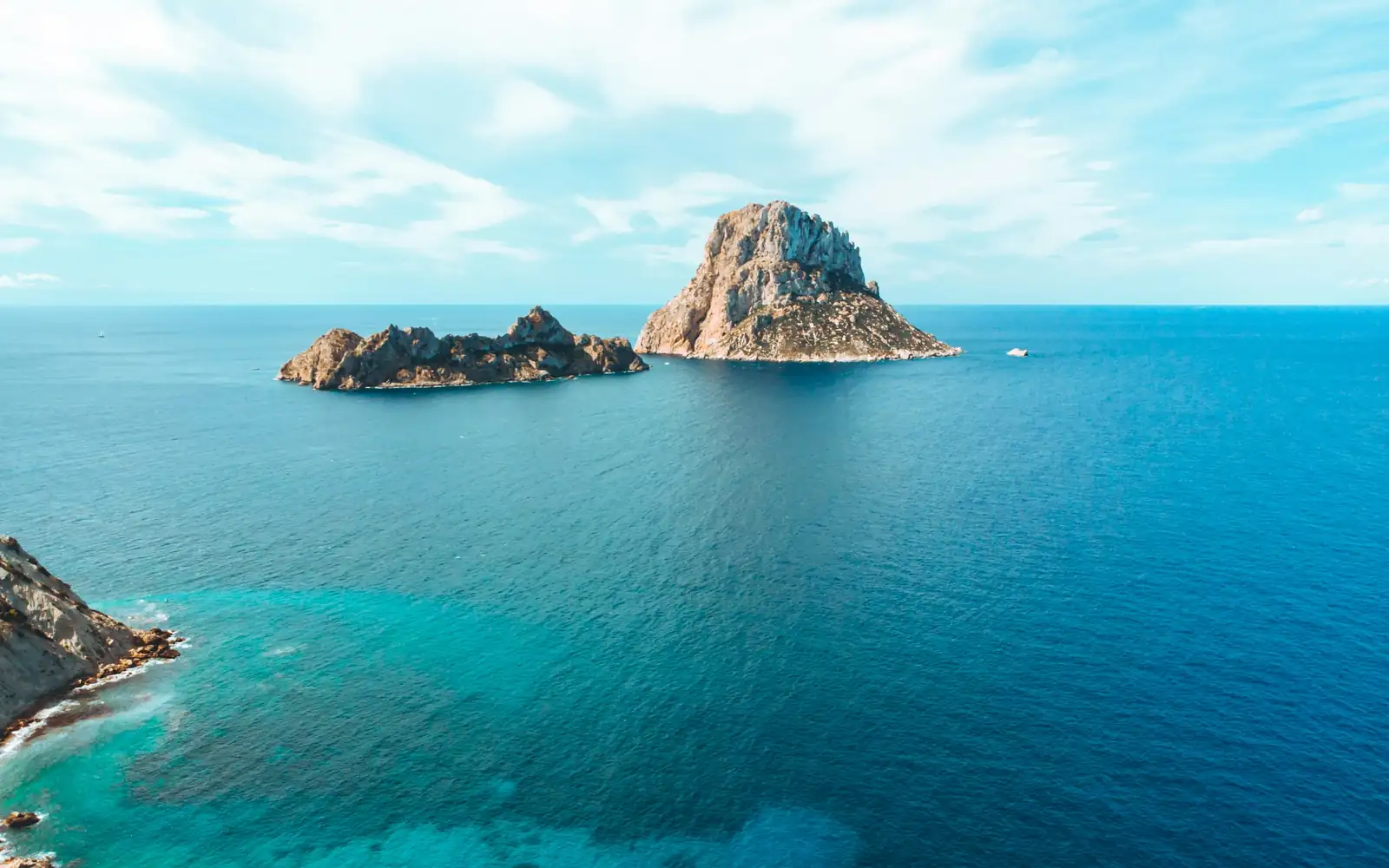 Es Vedra rock rising from a turquoise sea