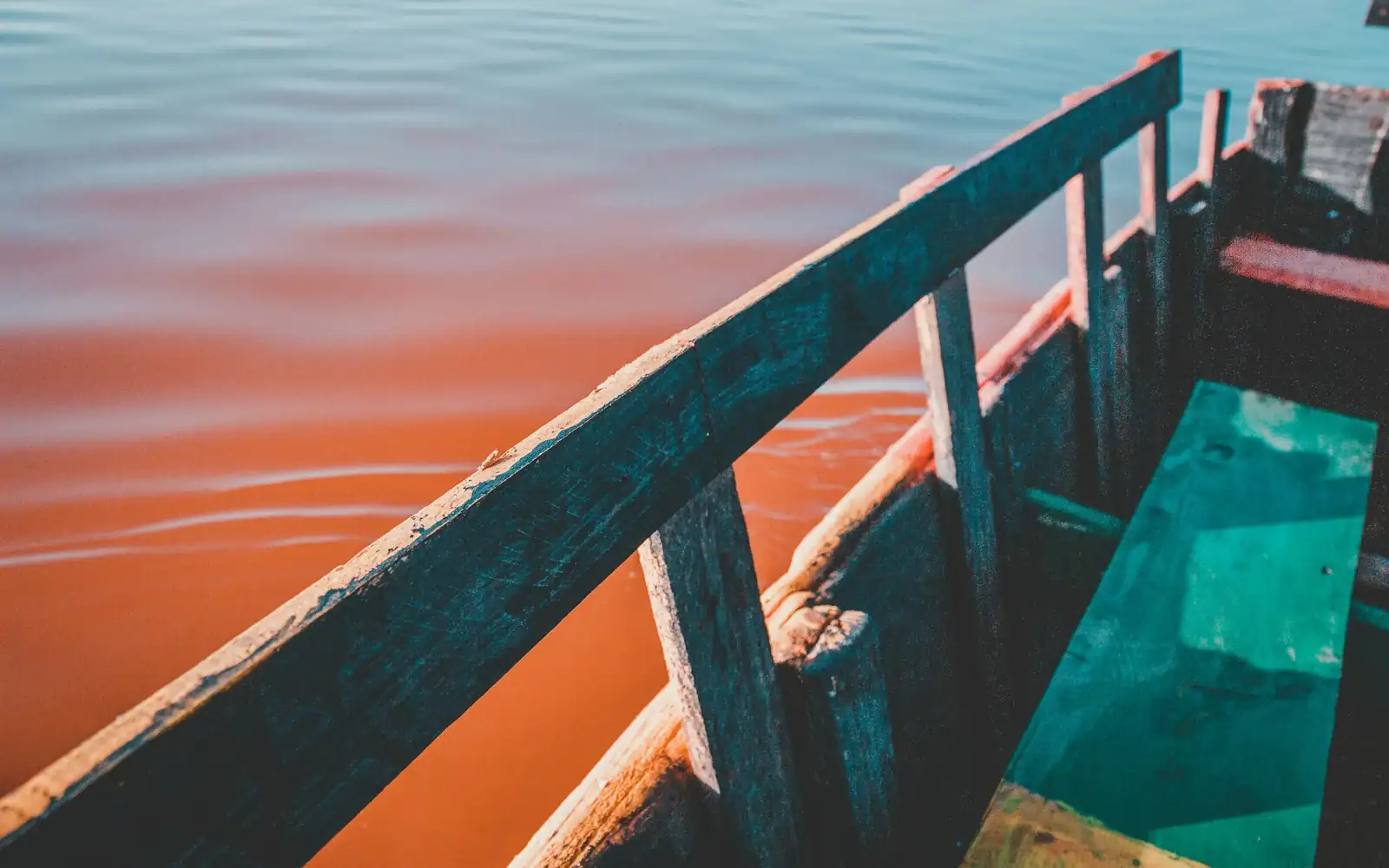 A boat on the pink waters of a salt lake