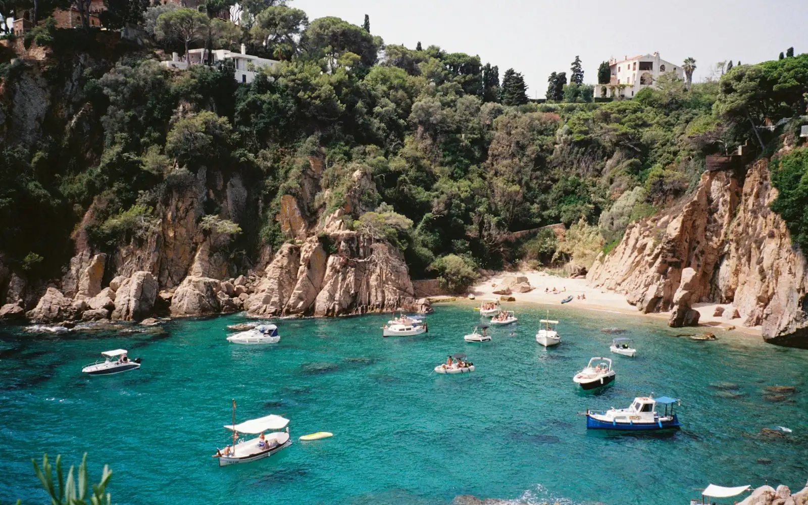 A turquoise cove with boats on the Costa Brava