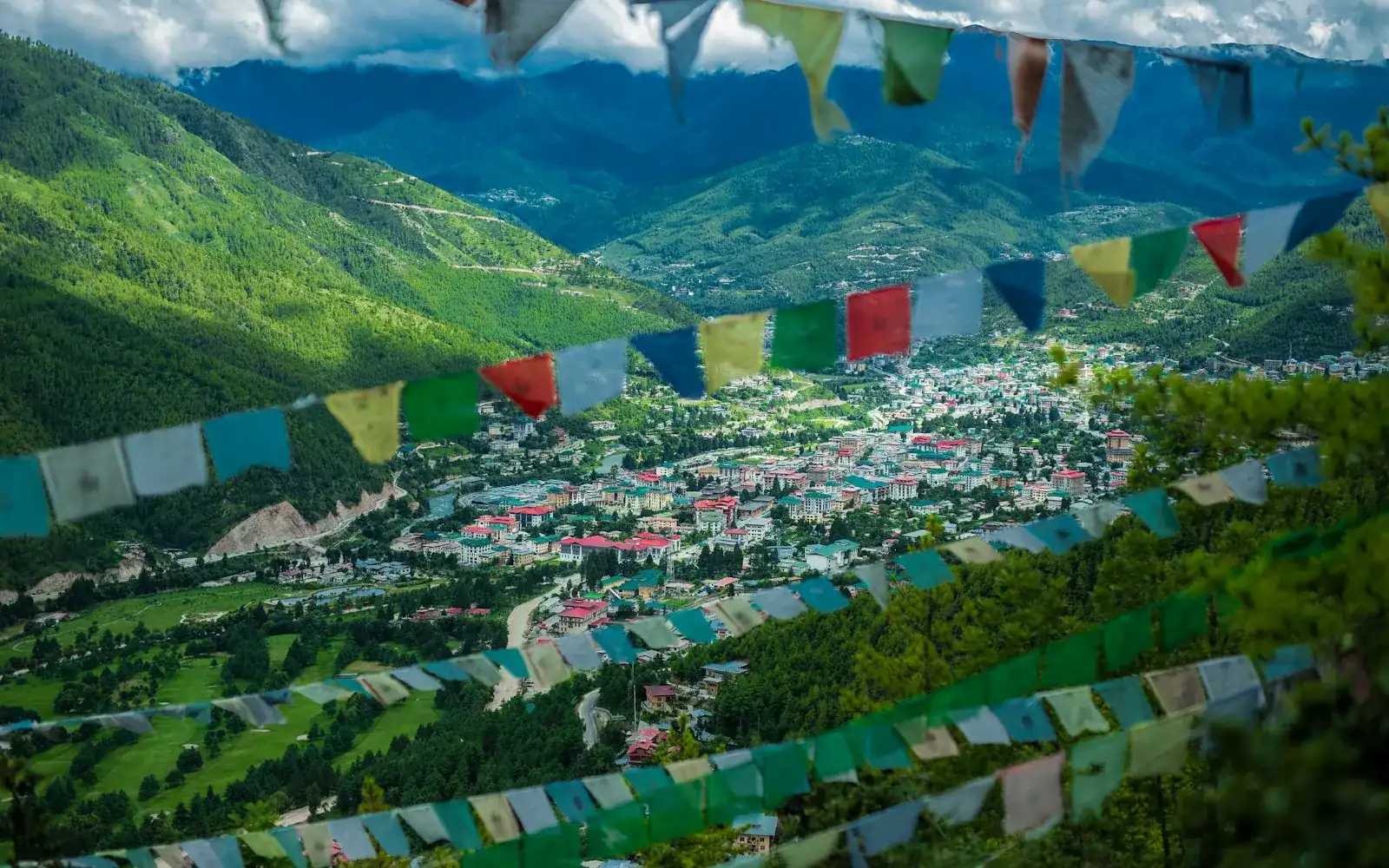 A mountain valley framed by prayer flags
