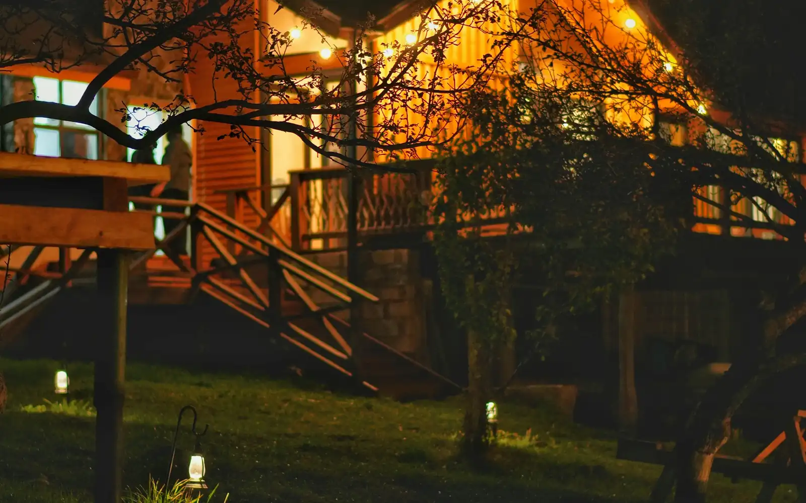 A lit treehouse suite in the forest canopy