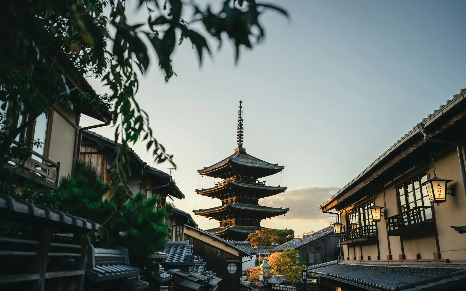 A pagoda on a quiet Kyoto street at dusk