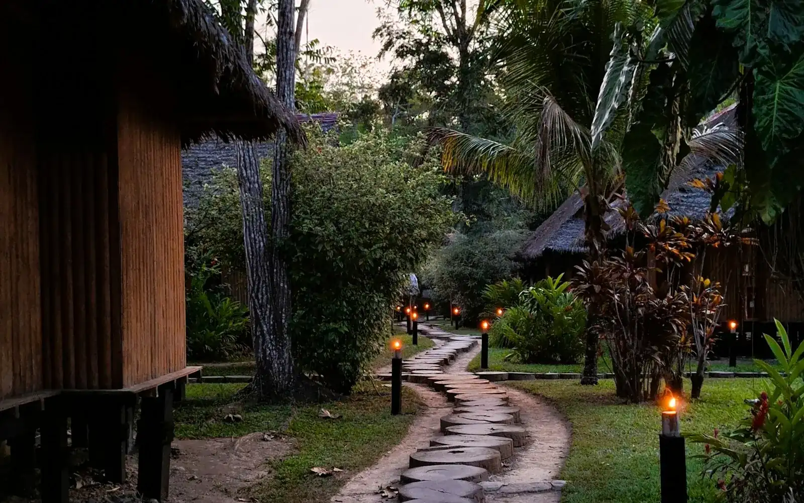 A stone path to a lodge among the trees